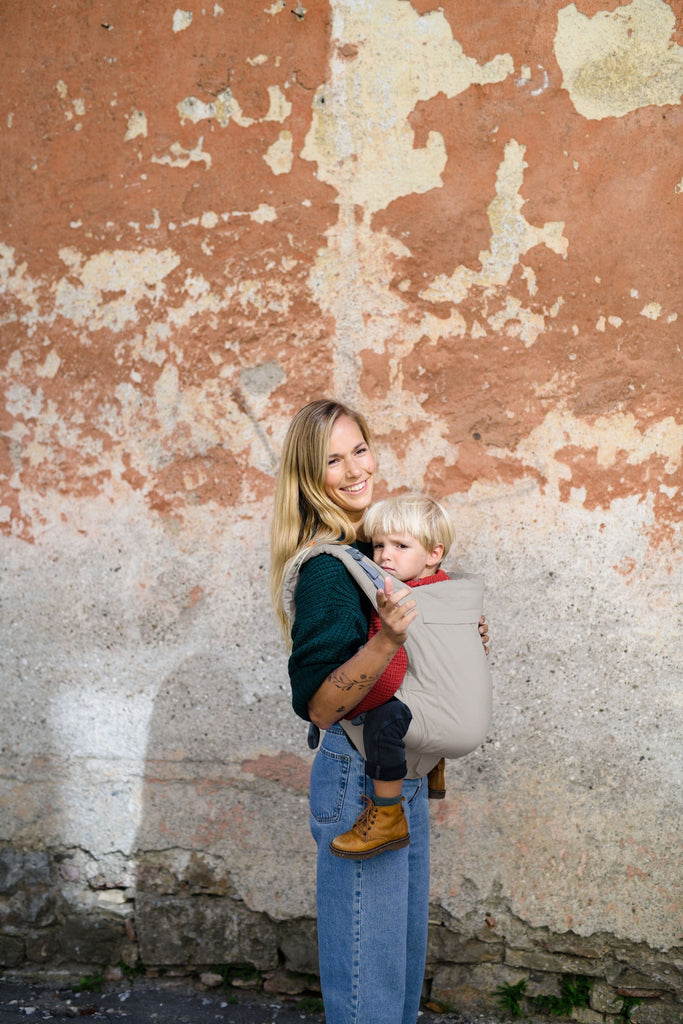 Beco Toddler Carrier in ecru, shown with toddler in the front carry position