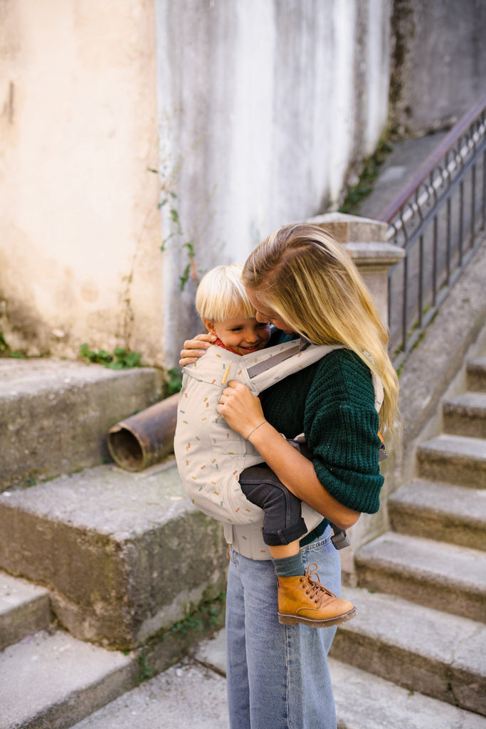 Beco Toddler Carrier in Sprinkles pattern - shown from the back with toddler in the front carry position