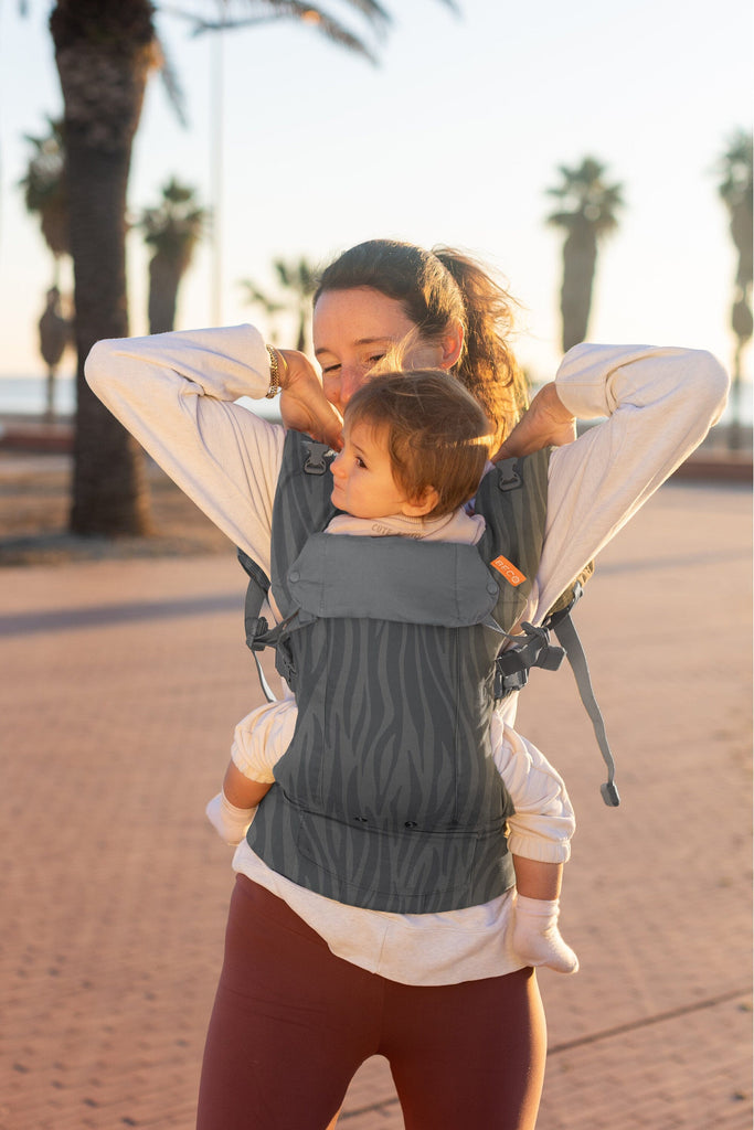 Baby in the Beco Gemini Baby Carrier in Dark Zebra pattern