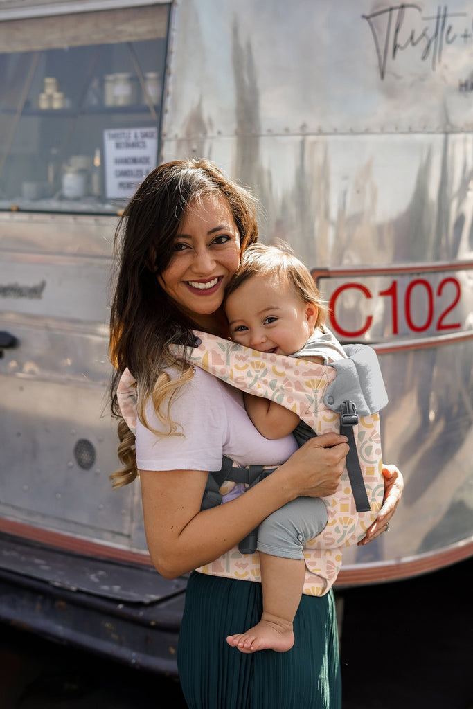 Beco Baby Carrier in Sprinkles pattern - shown with toddler in the front carry position