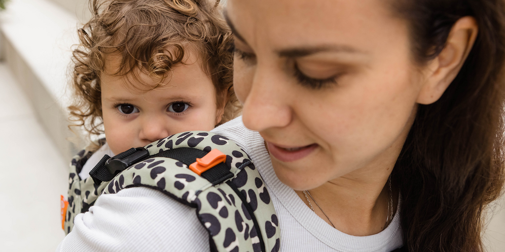 Toddler in back carry Beco Gemini in jade leopard