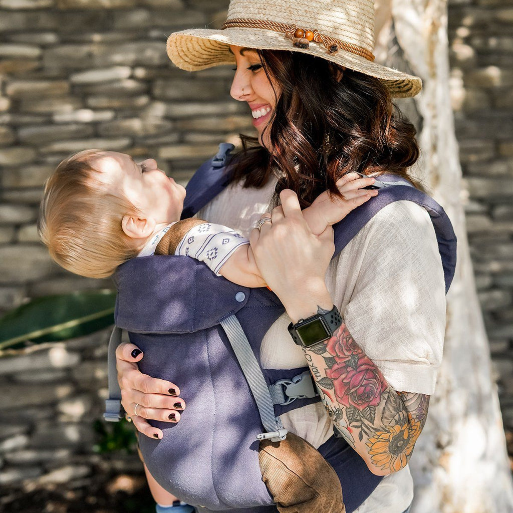 Baby in front carry in the Beco Gemini Baby Carrier in Blue Linen