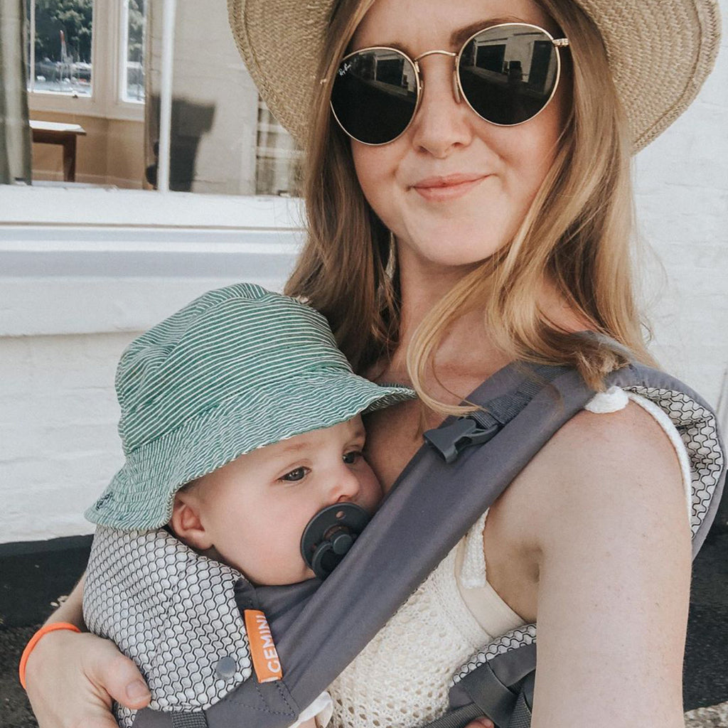 Baby facing in being carried in a grey Gemini Beco carrier