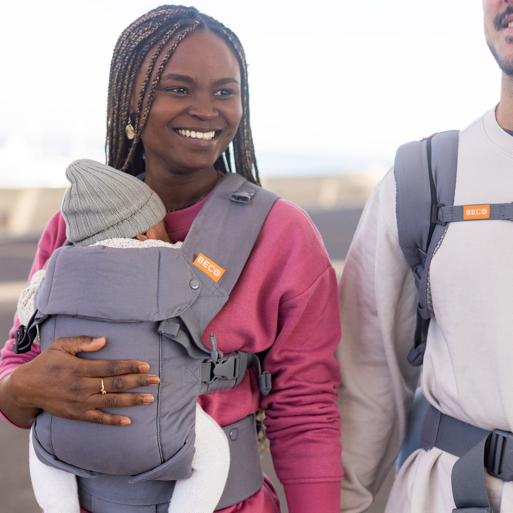 Baby in front carry facing in Beco carrier in grey