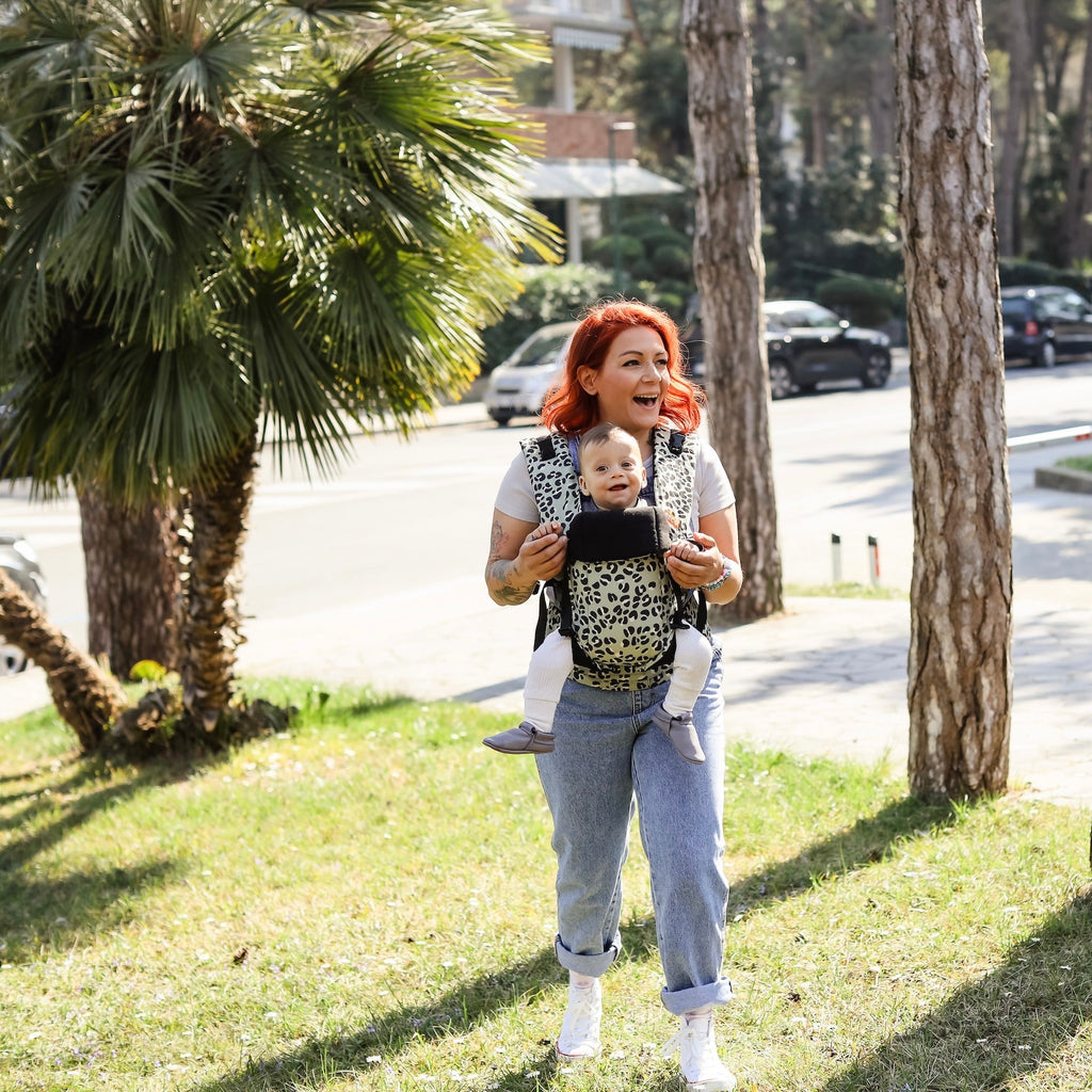 Baby front carry facing out in the Beco Gemini baby carrier in jade leopard pattern