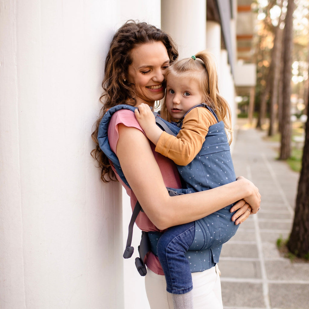 Beco Toddler Carrier in Moonlight Stardust pattern, shown with toddler in the front carry position