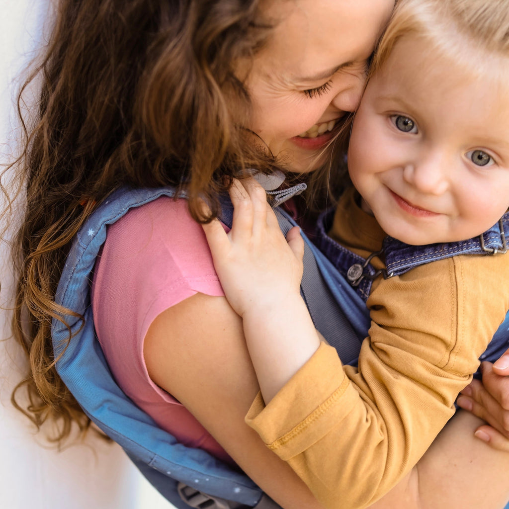 Beco Toddler Carrier in Moonlight Stardust pattern, shown with toddler in the front carry position