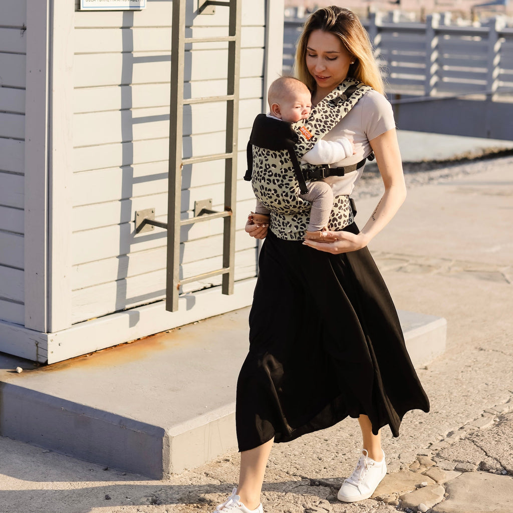 Baby front carry facing in in the Beco Gemini baby carrier in jade leopard pattern